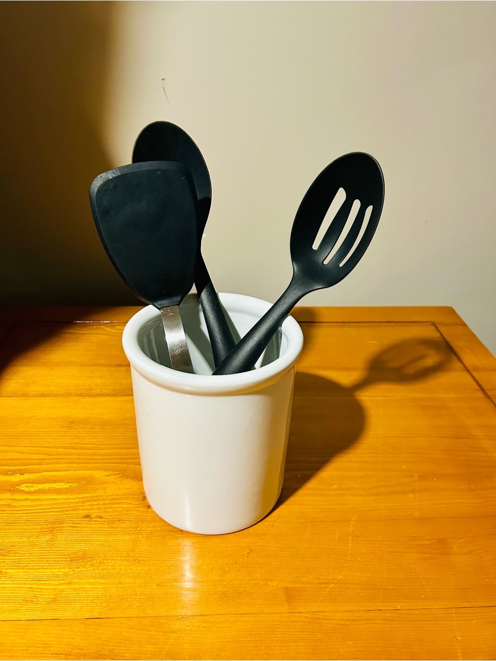 White Ceramic Utensil Holder with Black Kitchen Tools